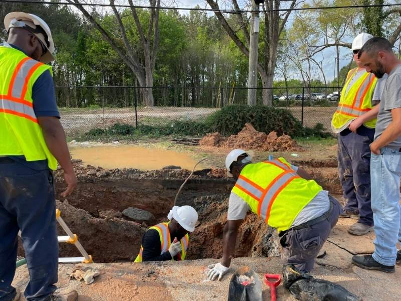 Construction crews and engineers inspecting underground utilities, showing why civil engineering firms check utility capacity early.