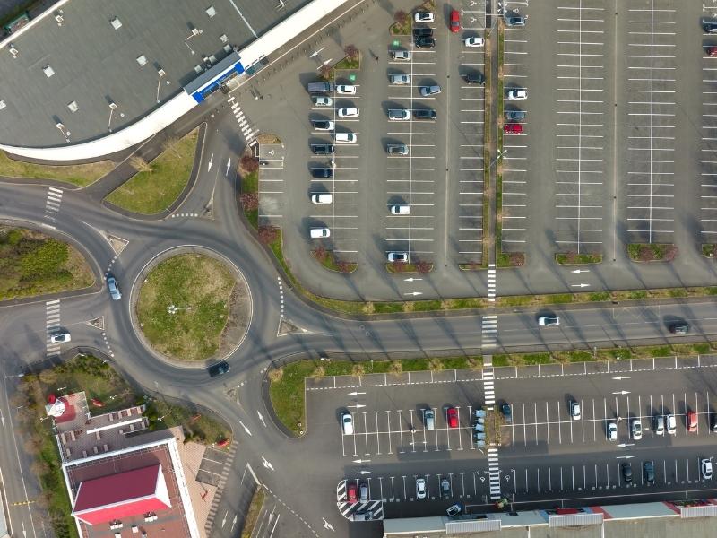Commercial site layout showing parking areas, drive aisles, and vehicle circulation that affect parking and traffic flow.